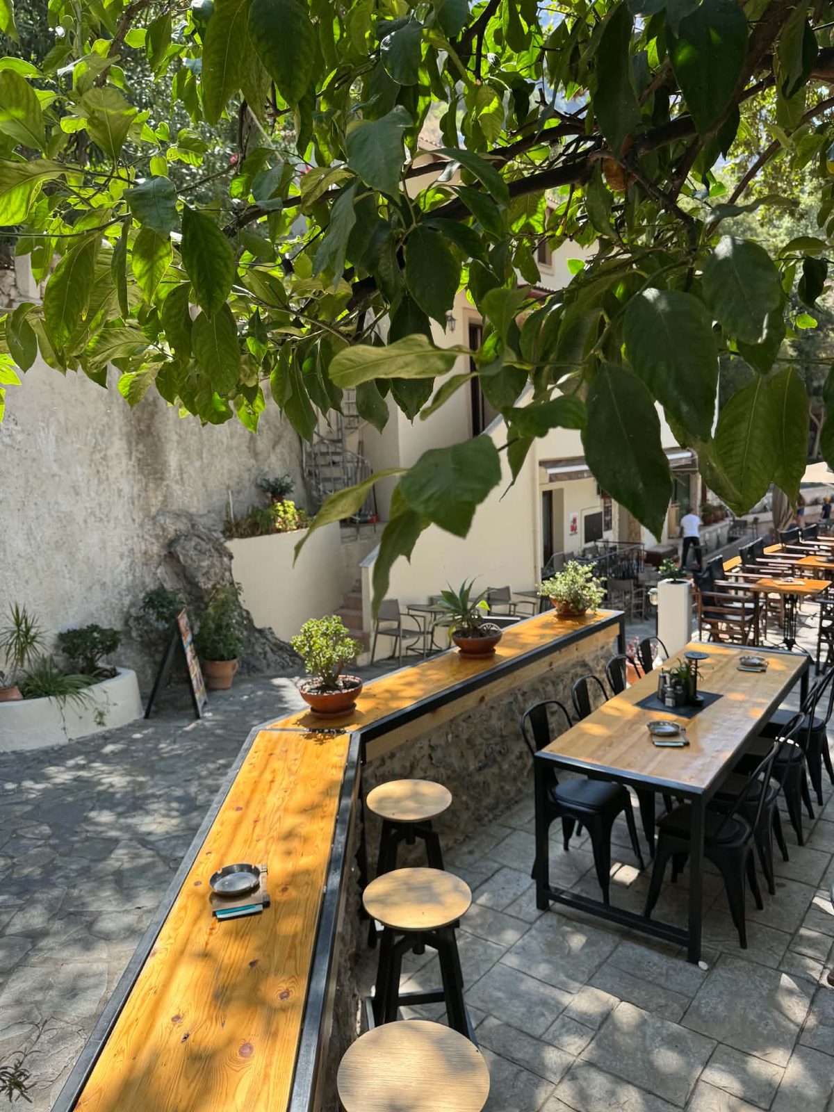 Tables in the shade of the plane tree at Platanos, Spili
